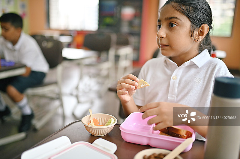 女学生在教室午休时吃健康午餐图片素材