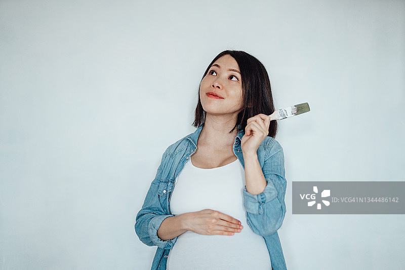 年轻孕妇为迎接宝宝的到来做准备图片素材