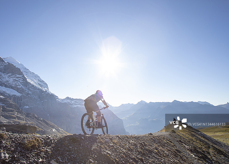朋友们在阳光明媚的山脊上骑山地自行车图片素材