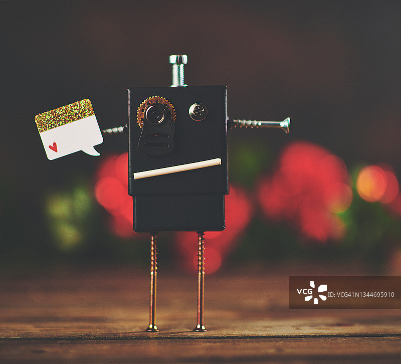 手工机器人举着空白卡片图片素材