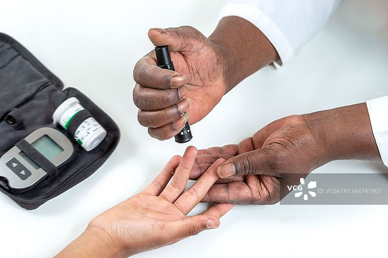 儿童糖尿病概念：儿童在家学习使用血糖仪图片素材