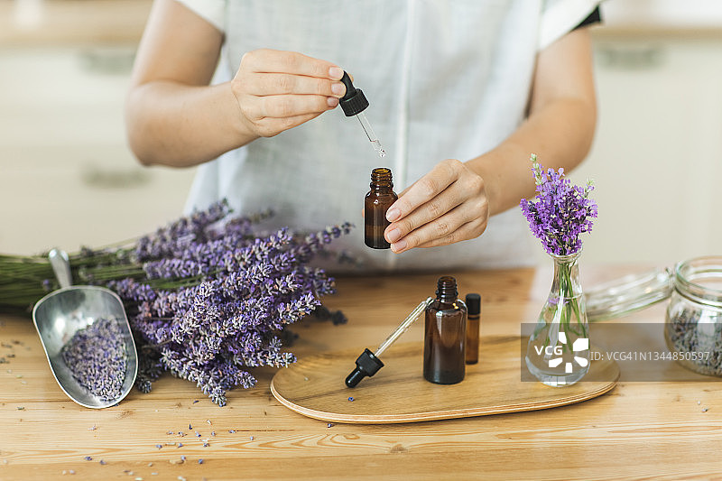 女人手持薰衣草精油滴管图片素材