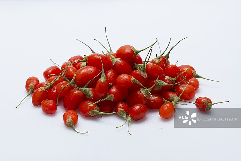 白色表面上的一堆新鲜枸杞图片素材