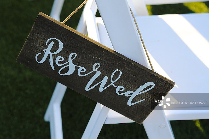 婚礼仪式上挂在椅子上的预留座位木牌图片素材