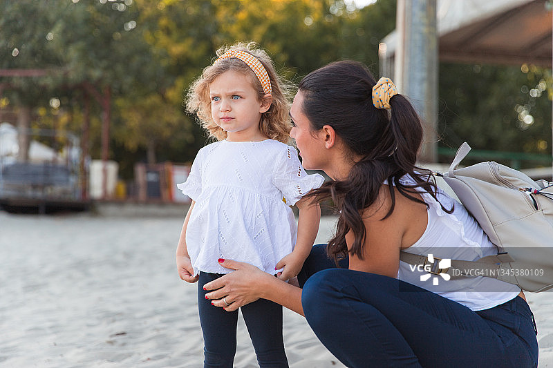 害怕的年轻女孩看着远方，母亲安慰她图片素材