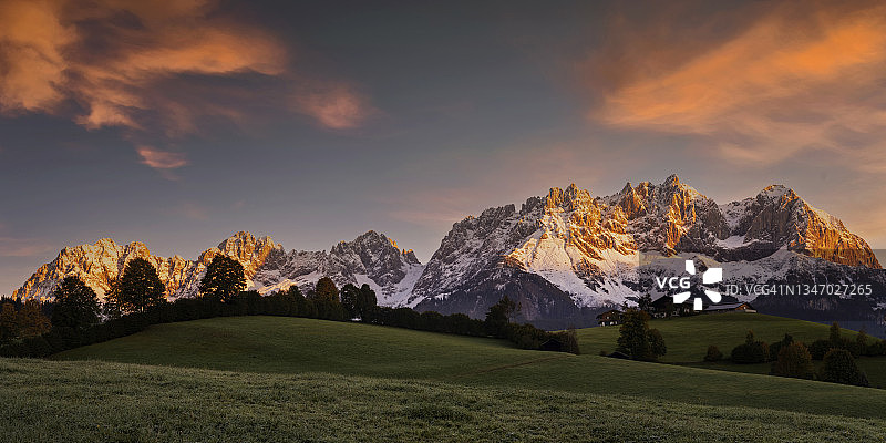田园诗般的阿尔卑斯山风光日出，奥地利维尔德皇帝山前的农舍，蒂罗尔-凯撒山脉图片素材