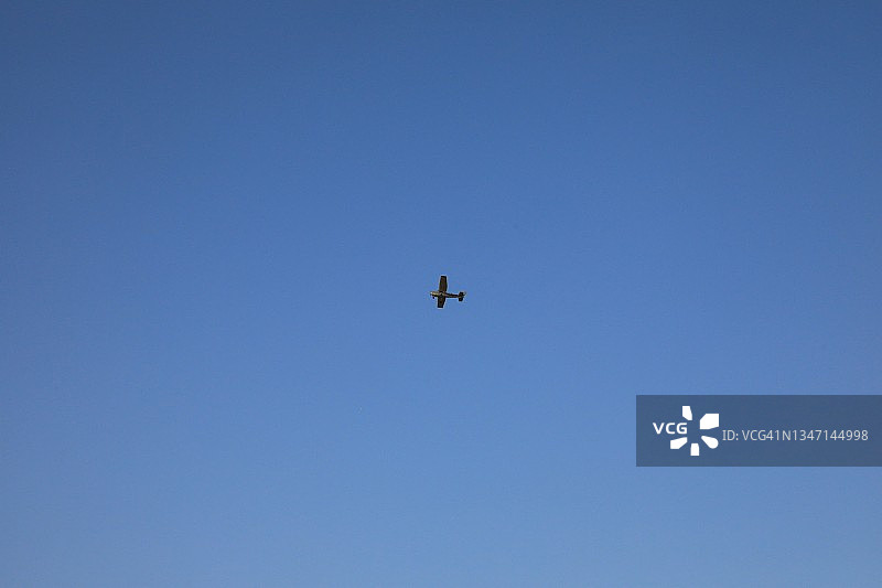 晴朗蓝天下远处的小飞机图片素材