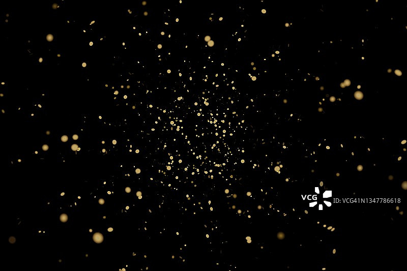 黑色背景上的金色纸屑，新年或生日庆典概念图片素材