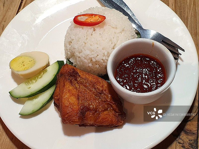 椰浆饭是传统马来西亚椰奶米饭，配辣椒酸辣酱、炸脆皮鸡、煮鸡蛋和黄瓜图片素材