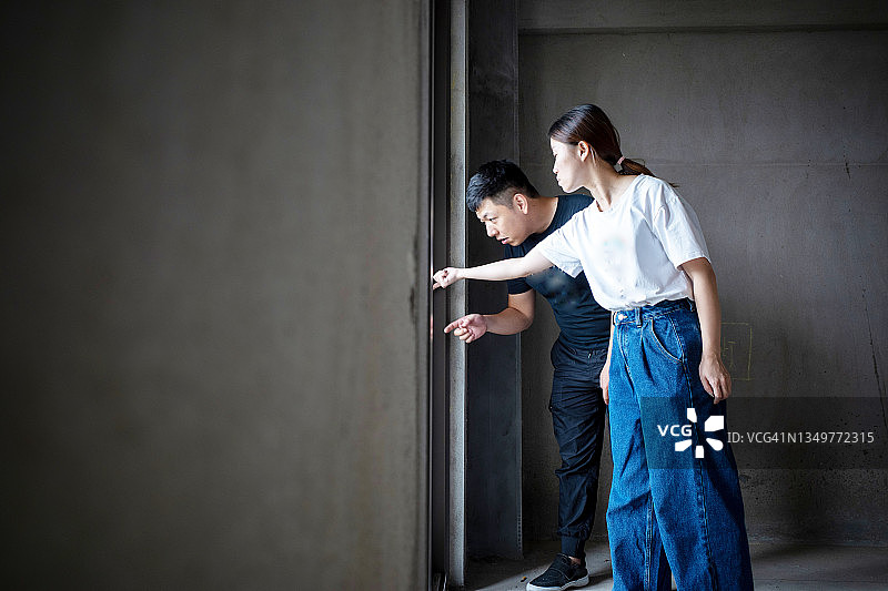 两个年轻人正在讨论门窗的装饰图片素材