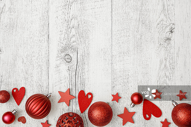 白色木桌上的红色圣诞树装饰品，留白图片素材