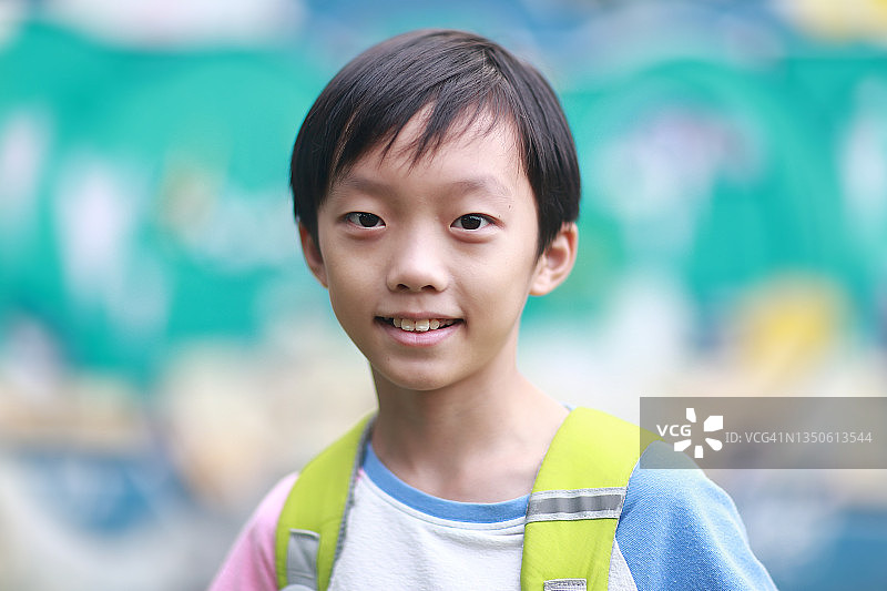 小男孩背着书包走在上学的路上图片素材