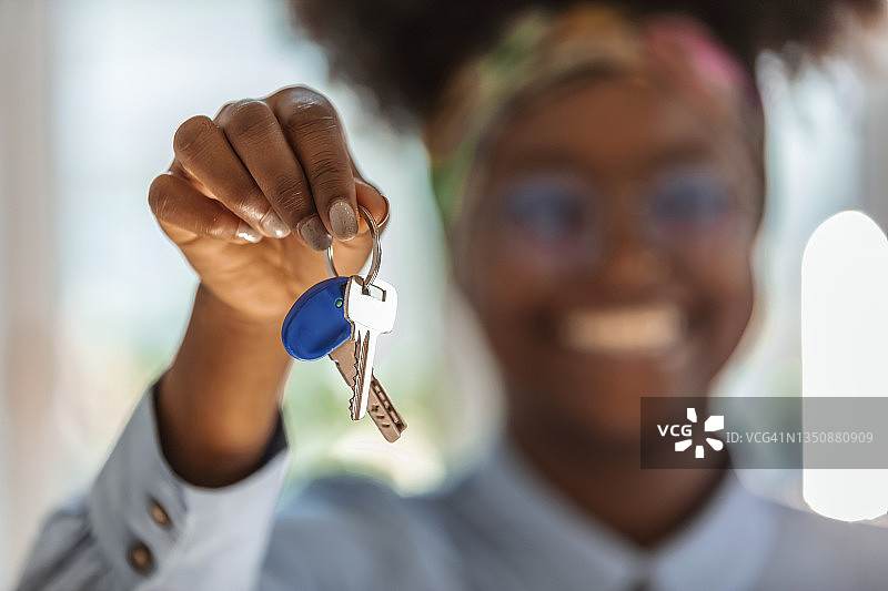 年轻真诚的非洲裔美国女子向镜头展示钥匙图片素材