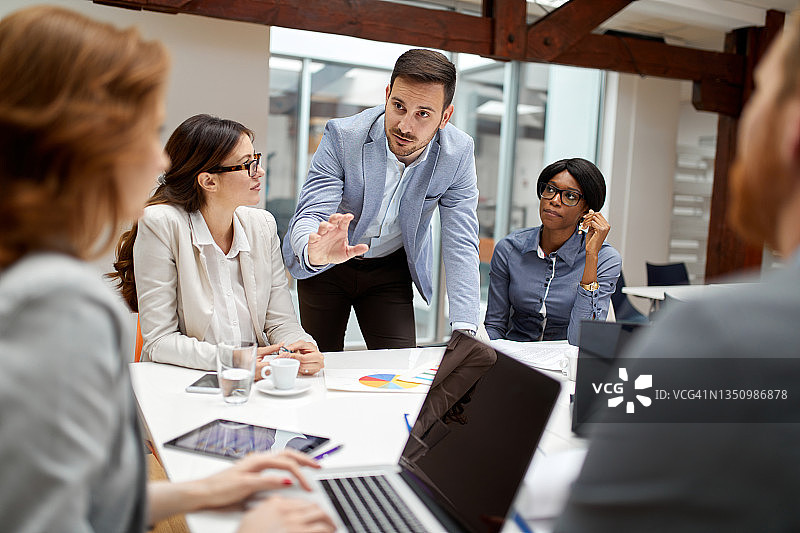商界伙伴在会议上讨论文件和想法图片素材