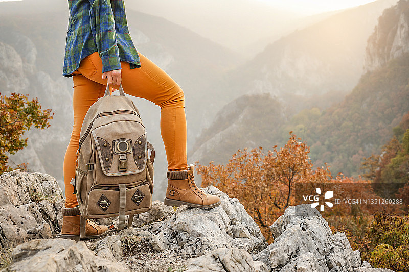 在山顶享受秋日的年轻女人图片素材