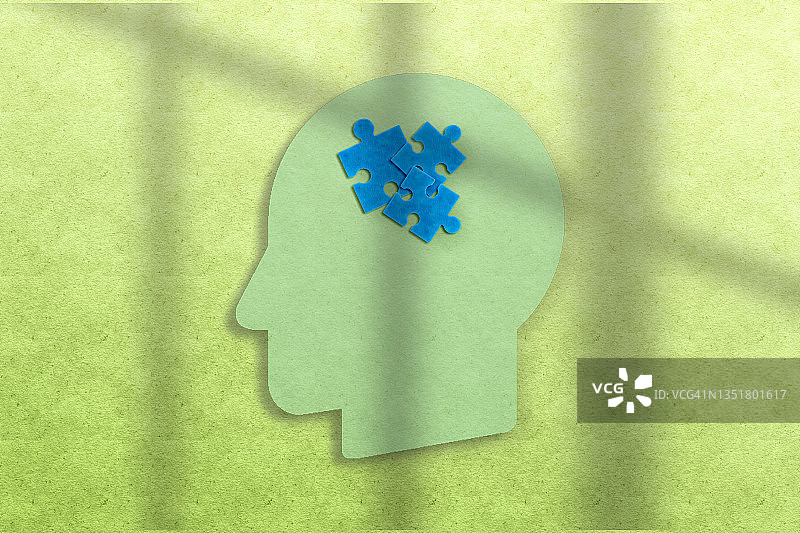拼图纸片头像-自闭症概念，绿色背景图片素材