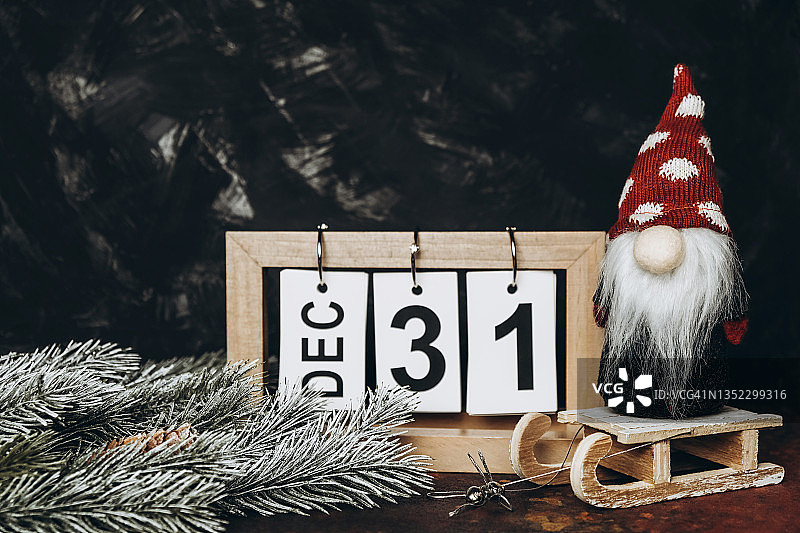 玩具雪橇上的松枝、日历和圣诞侏儒图片素材