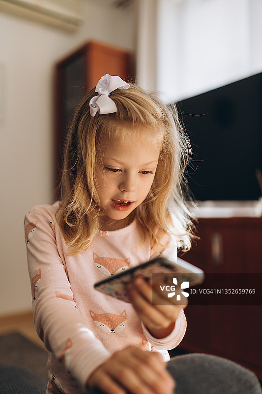 在家玩智能手机的女孩图片素材