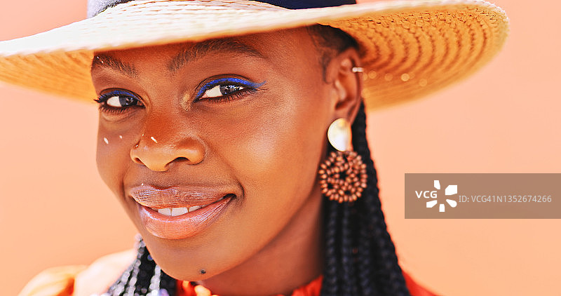 美丽的年轻女人穿着时髦的衣服，背景是橙色墙壁图片素材