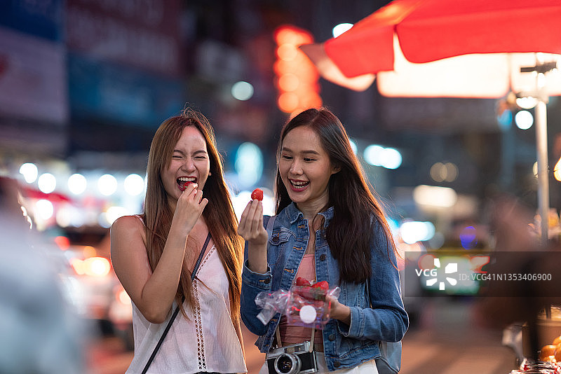在夜市品尝美食的游客图片素材
