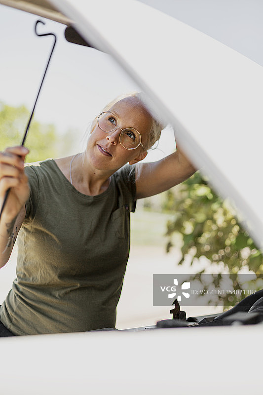 女人打开引擎盖图片素材