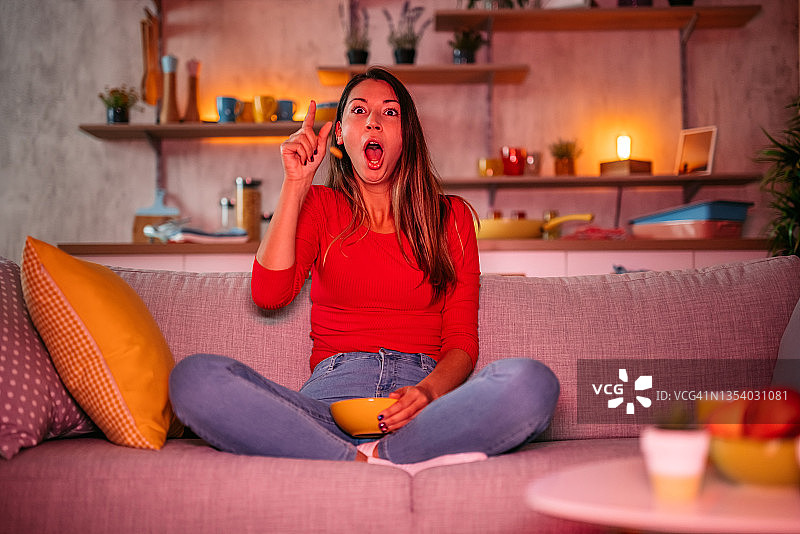 女人在看电影吃薯条时感到惊讶图片素材