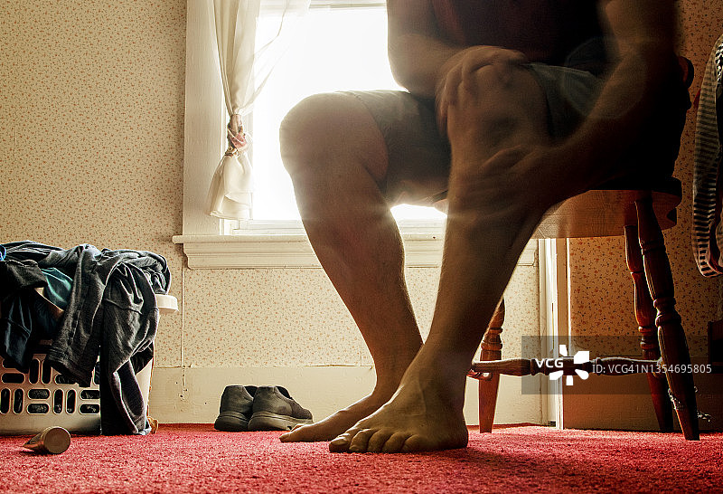 男人在受伤的腿上涂抹止痛膏图片素材