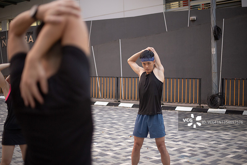 亚洲人在慢跑前一起热身图片素材