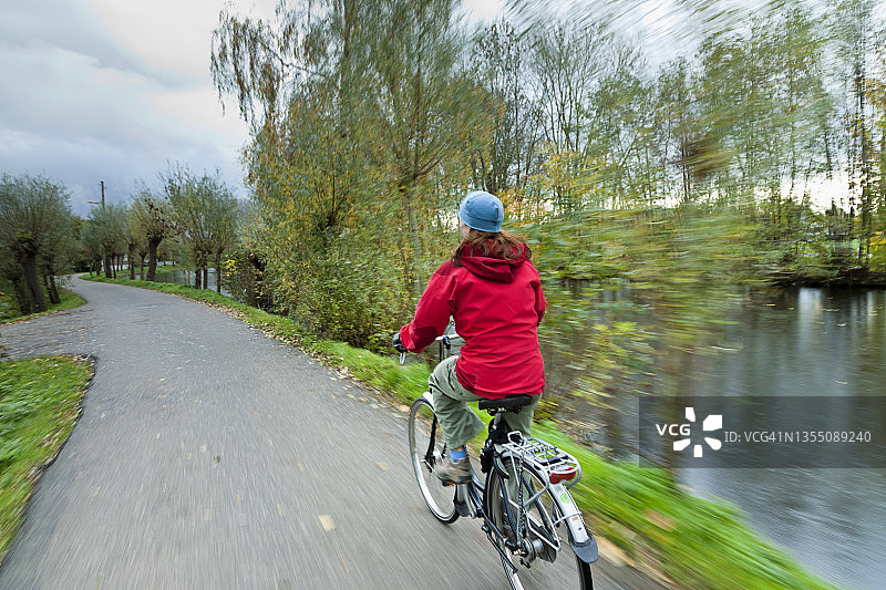 女人在荷兰南荷兰省豪达附近骑自行车图片素材