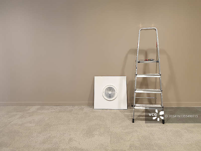 客厅里的折叠梯子和白色沙发椅竖版照片图片素材