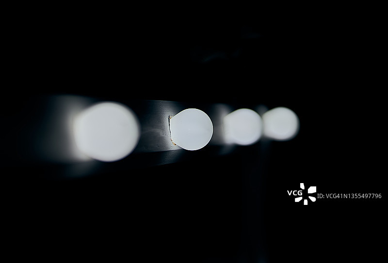 一排白色灯泡的灰度特写图片素材