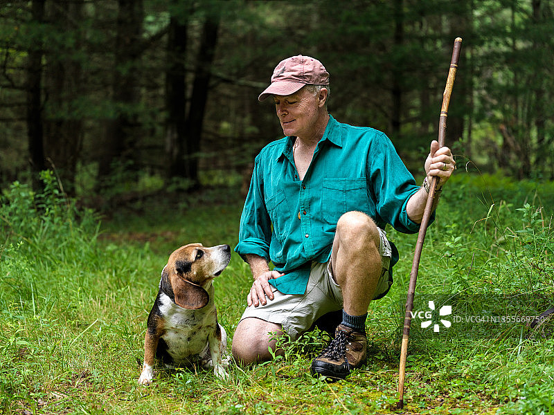 与狗在乡间徒步旅行的男人图片素材