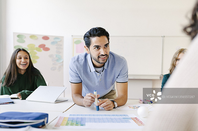 老师在课桌旁辅导学生图片素材
