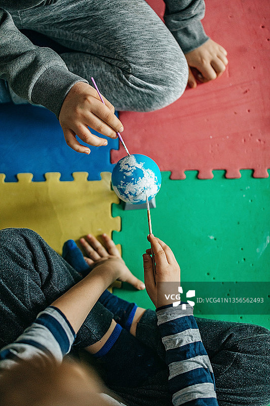 两个男孩在玩耍并制作太阳系模型图片素材