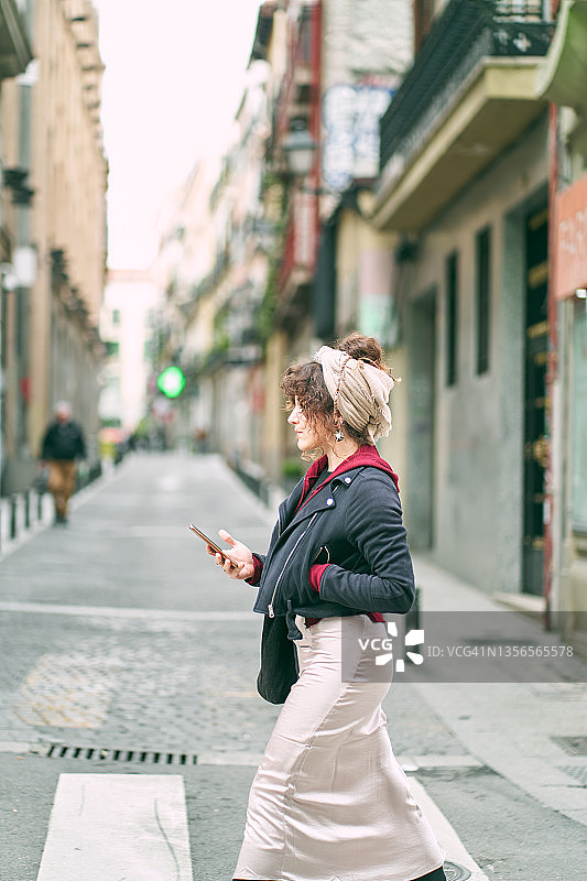 女人在街上边走边看手机图片素材