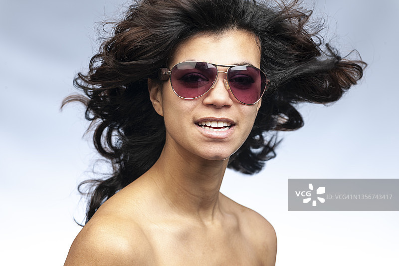 戴着太阳镜的迷人拉丁年轻女人图片素材