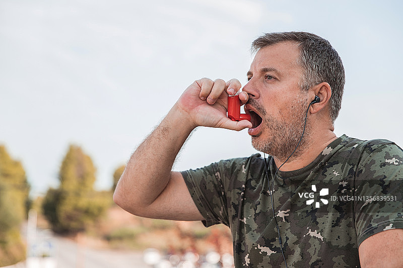 年长的男人使用吸入器图片素材