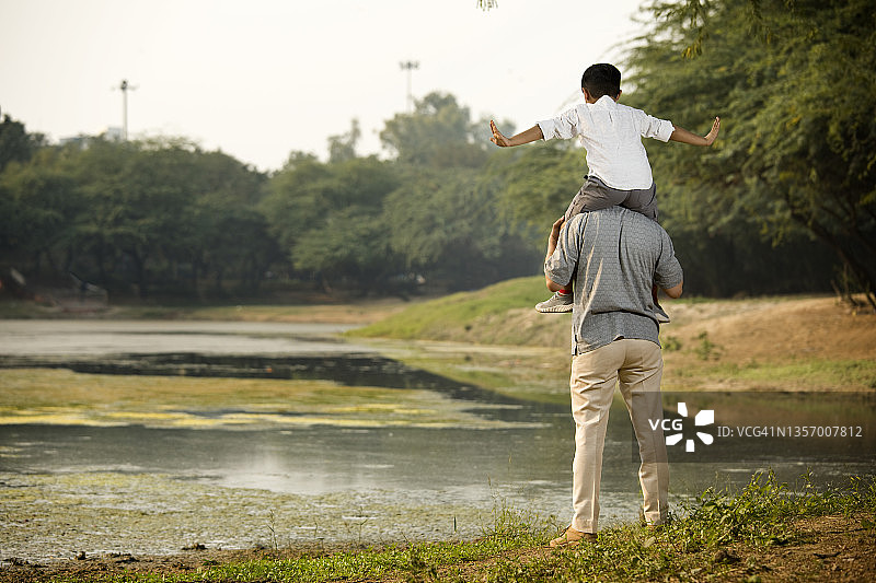 爷爷和孙子在河边欣赏自然风光图片素材