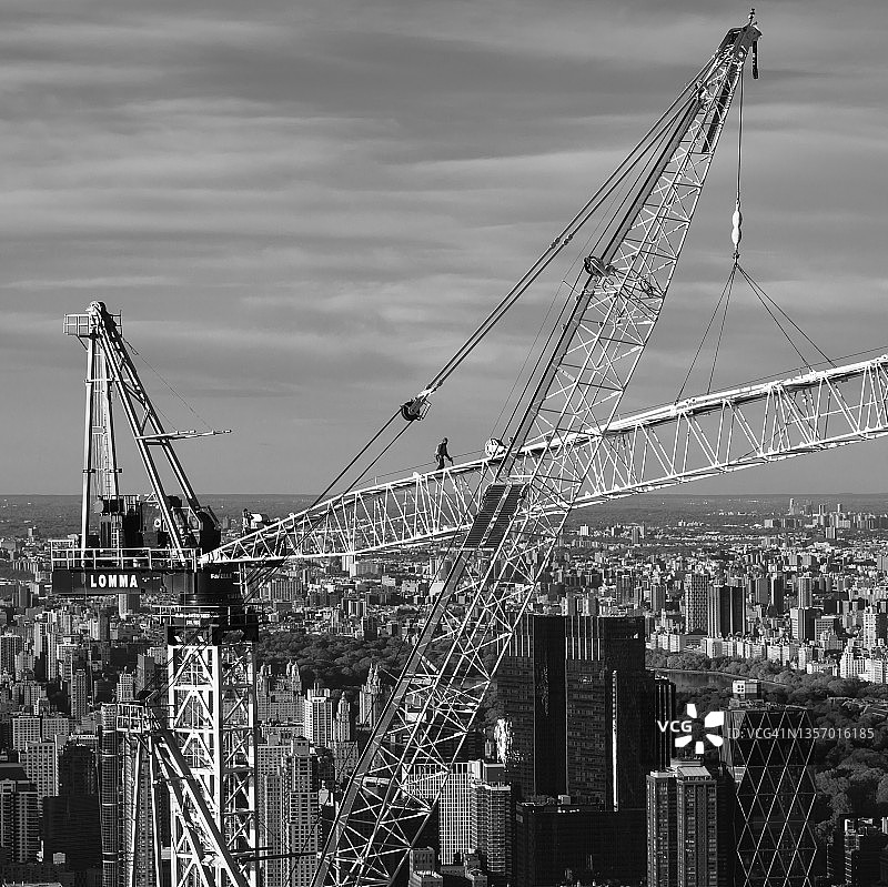男人在高层建筑的起重机上图片素材