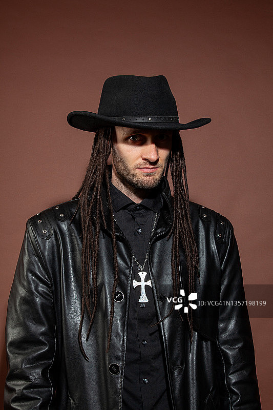 30岁男子在棕色背景下的特写工作室肖像图片素材