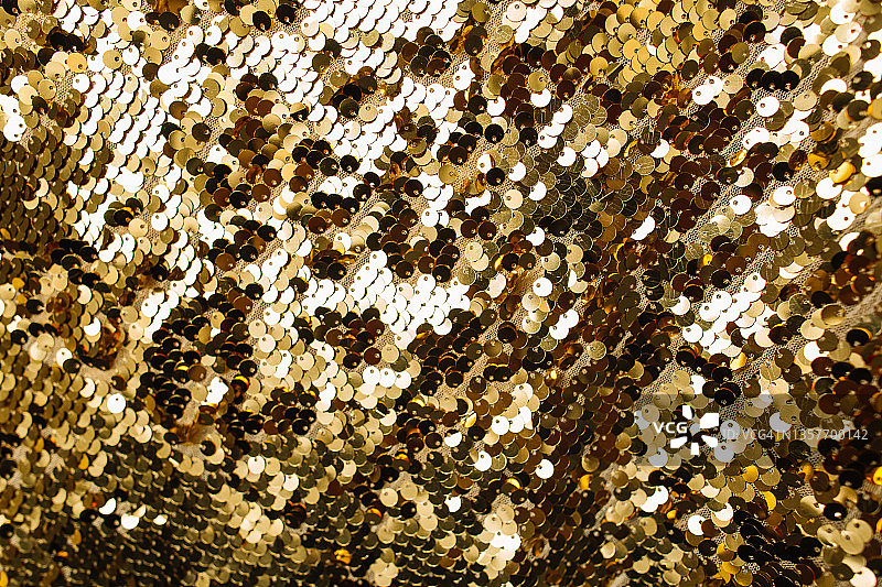 带有闪亮亮片的金色纺织面料背景图片素材