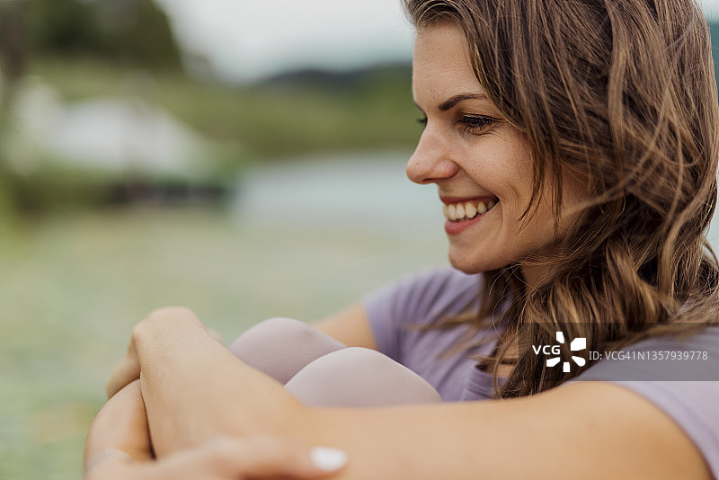 湖边的微笑棕发女子图片素材