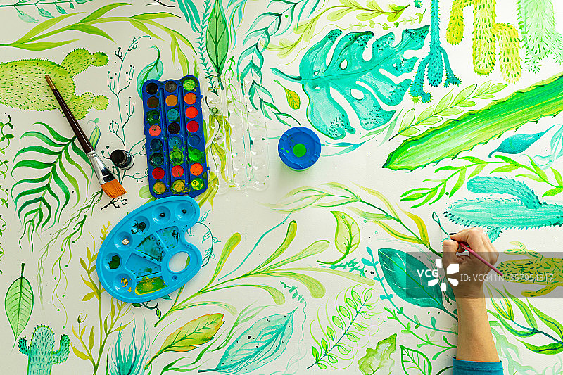 身份不明的创意女艺术家用水彩绘画植物图片素材