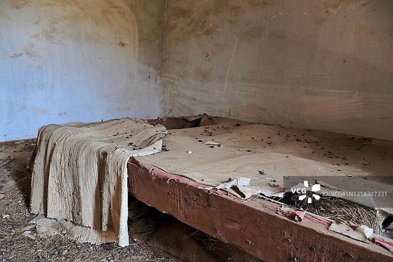 被拆毁的床架，有毯子和鸽子粪便，破损的床，废弃的房屋，西班牙安达卢西亚图片素材