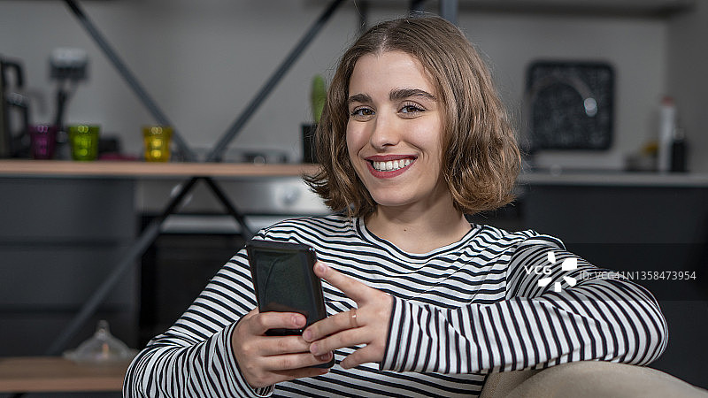 年轻女子用智能手机上网与刚认识的男孩聊天图片素材