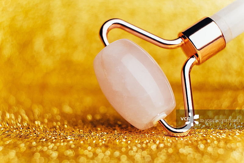 金色亮片背景上的刮痧滚轮图片素材