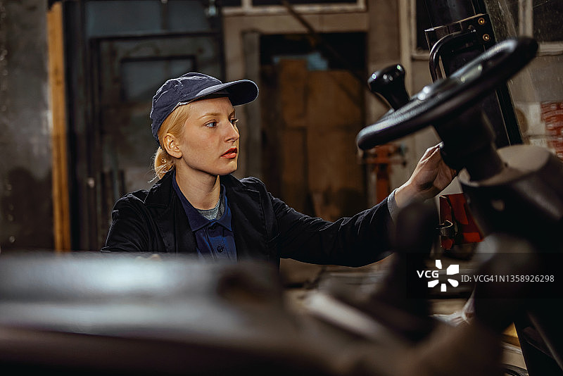 年轻严肃的女工程师登上叉车图片素材