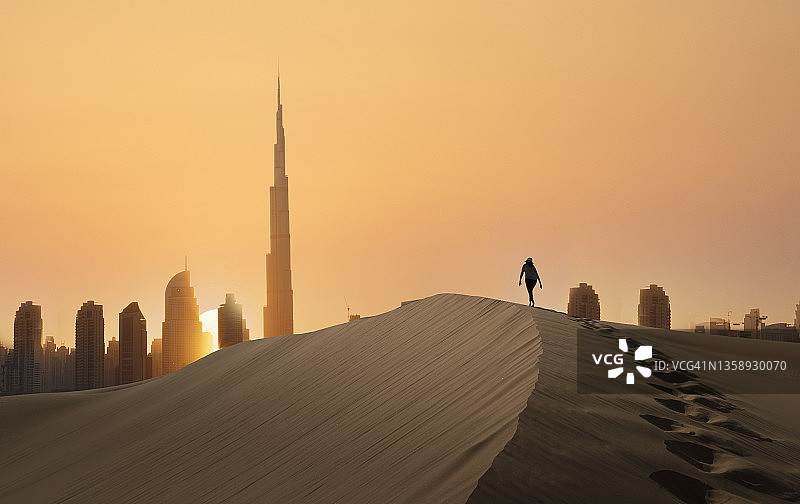 沙丘上的女人与未来城市图片素材