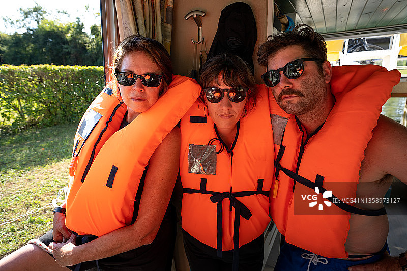 在小型自驾驳船上穿救生衣的人们图片素材
