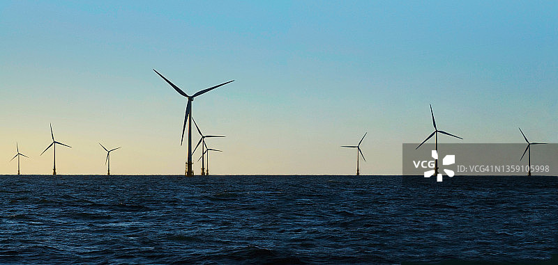 蓝天下水中的风力涡轮机图片素材